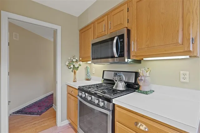 a kitchen with stainless steel appliances granite countertop a stove a microwave and cabinets