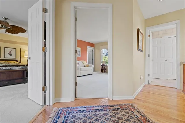 a view of a bedroom with a bed and wooden floor