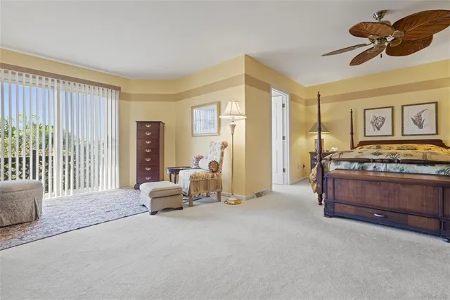 a bedroom with furniture and large window