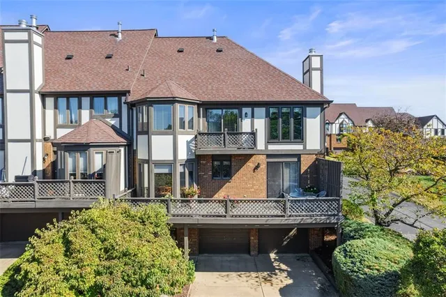 a front view of a house with a garden and plants