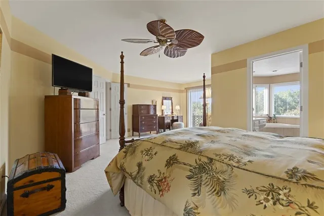 a bedroom with a bed and a flat tv screen