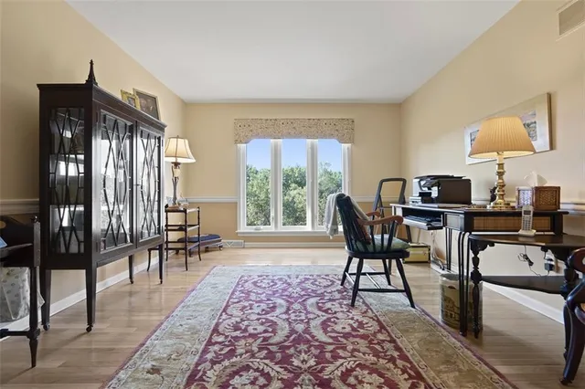 a living room with a rug and a wooden floor