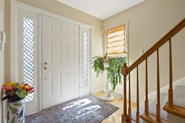 a view of entryway with wooden floor and front door