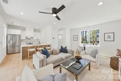 a living room with furniture and kitchen view