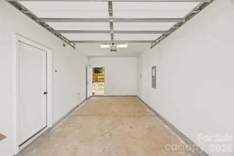 en empty room with ceiling fan and window