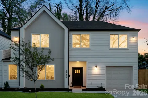 a view of a house with yard and tree s