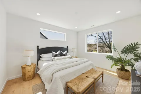 a bedroom with bed and a potted plant