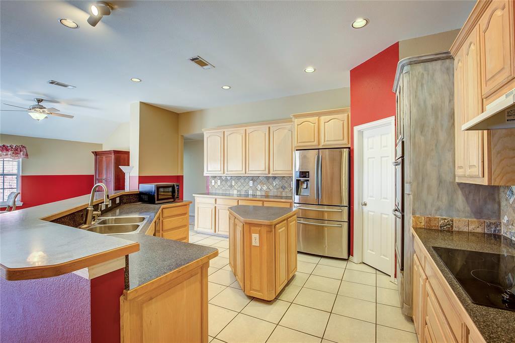 1157 Zajic Drive Terrell, TX 75160 - Photo 24 of 39 Kitchen with light brown cabinetry, black appliances, light tile patterned floors, tasteful backsplash, and recessed lighting