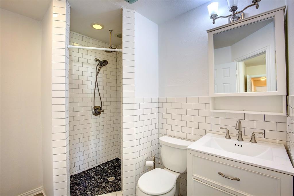 1157 Zajic Drive Terrell, TX 75160 - Photo 34 of 39 Bathroom with a stall shower, vanity, and tile walls