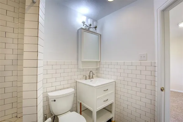 a bathroom with a sink a toilet and vanity