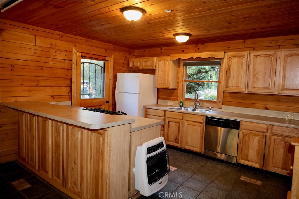 37023 Alder Drive Yucaipa, CA 92399 - Photo 11 of 34 a kitchen with stainless steel appliances granite countertop a stove a sink dishwasher and a microwave oven with cabinets