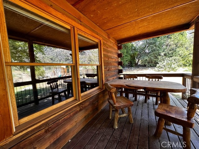 37023 Alder Drive Yucaipa, CA 92399 - Photo 29 of 34 a view of a patio with table and chairs with wooden floor and fence