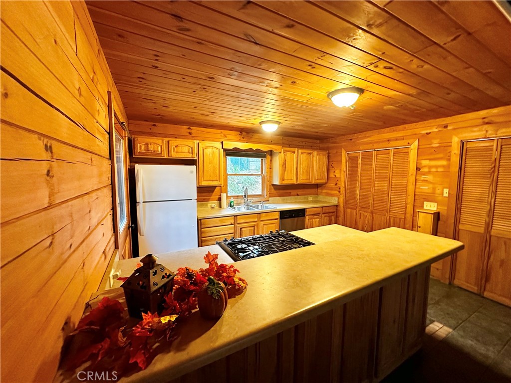 37023 Alder Drive Yucaipa, CA 92399 - Photo 8 of 34 a kitchen with stainless steel appliances kitchen island granite countertop a sink and cabinets