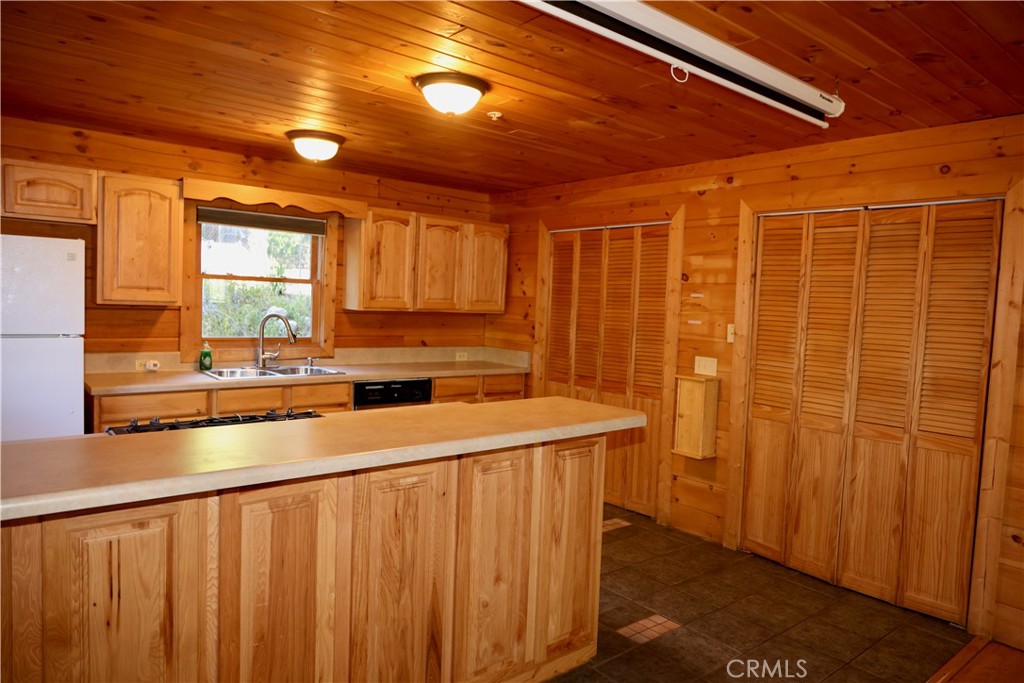 37023 Alder Drive Yucaipa, CA 92399 - Photo 9 of 34 a view of a kitchen with a sink and dishwasher
