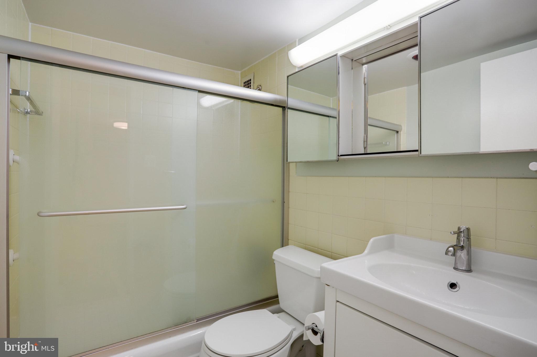 510 N Street Southwest, Unit N430 Washington, DC 20024 - Photo 15 of 29 a white toilet sitting next to a bathroom sink