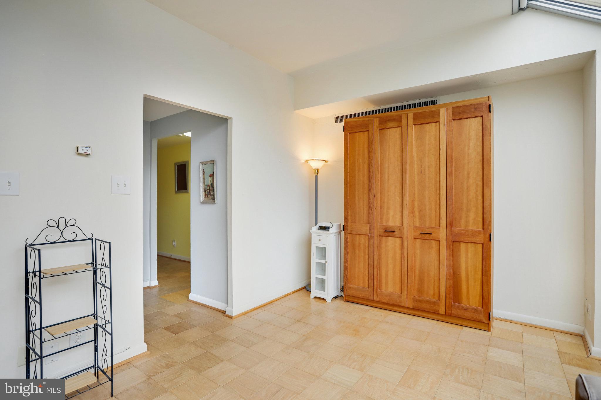 510 N Street Southwest, Unit N430 Washington, DC 20024 - Photo 3 of 29 an empty room with closet and mirror