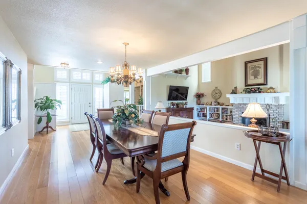 a view of a dining room with furniture and wooden floor