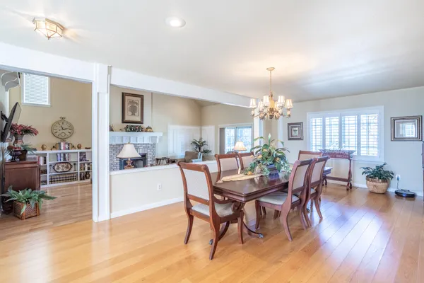 a view of a dining room with furniture window and wooden floor