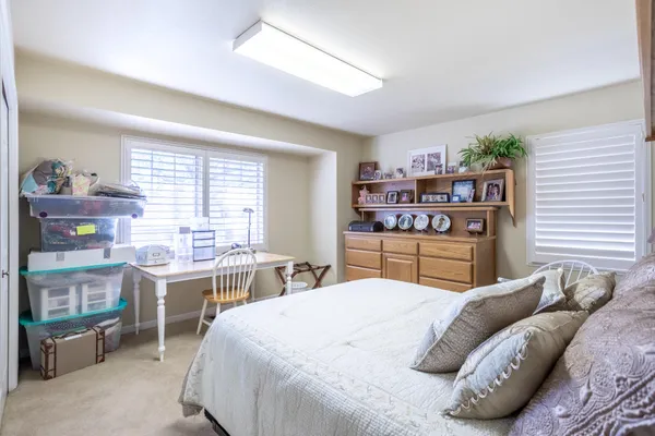 a large living room with stainless steel appliances kitchen island granite countertop a table chairs in it