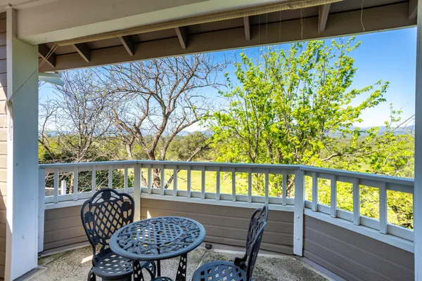 a view of a house with a big yard and large trees