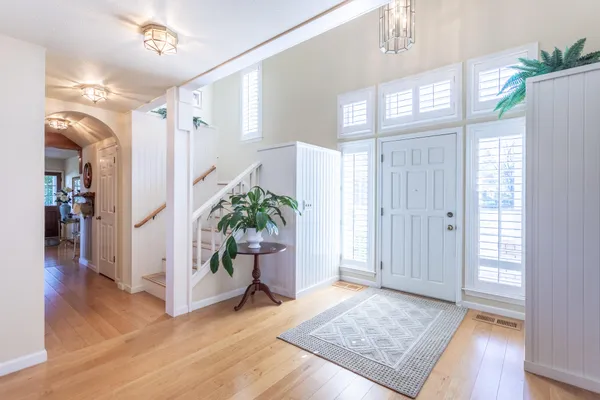 a living room with furniture a fireplace and a large mirror