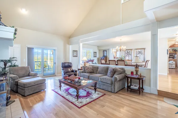 a living room with furniture a fireplace and a large window