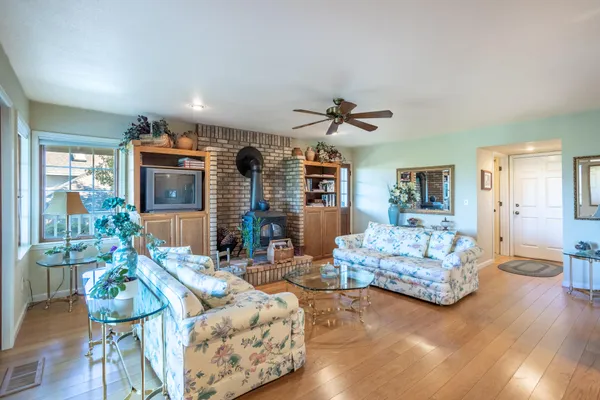 a living room with fireplace furniture and a chandelier