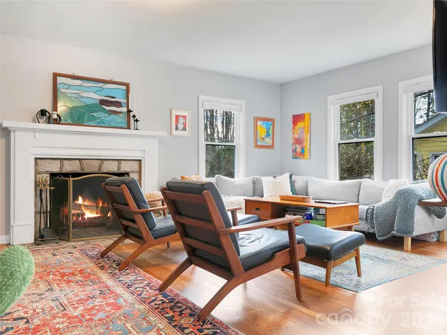a living room with furniture and a fireplace