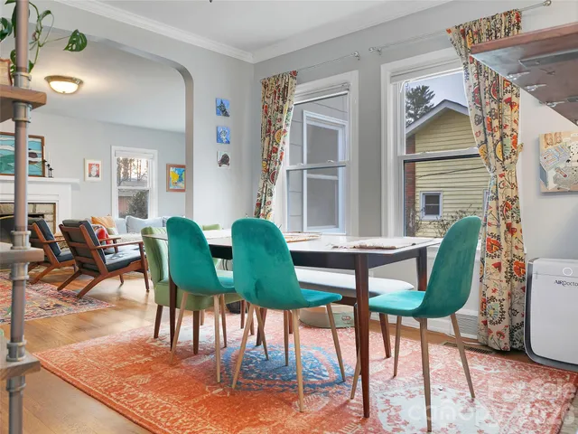 a view of a dining room with furniture and a potted plant