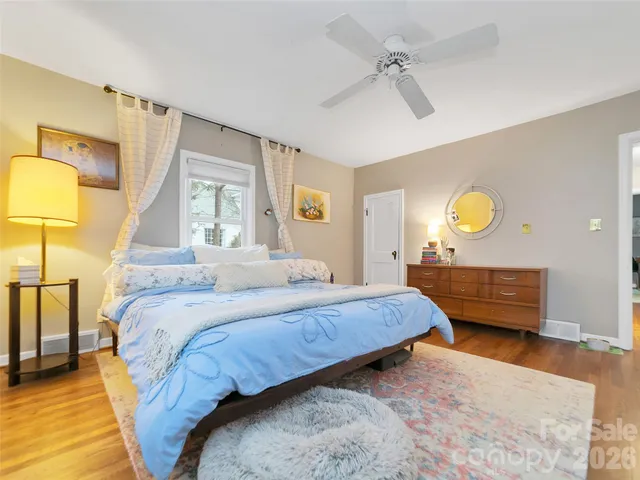 a bedroom with a bed and a lamp