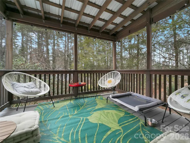 a balcony with a table and chairs