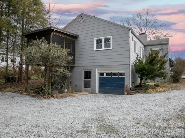 a backyard of a house with barbeque oven and outdoor seating