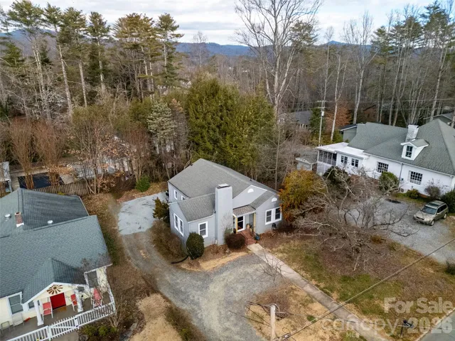 a aerial view of a house with large trees