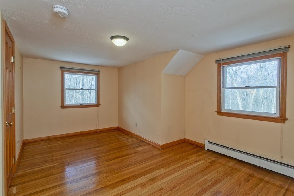 200 Town Farm Road Monson, MA 01057 - Photo 11 of 42 an empty room with wooden floor and windows