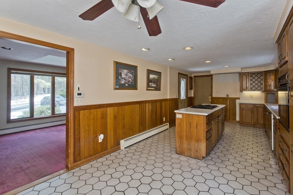 200 Town Farm Road Monson, MA 01057 - Photo 17 of 42 a kitchen with stainless steel appliances granite countertop a sink a stove top oven a chimney and a window