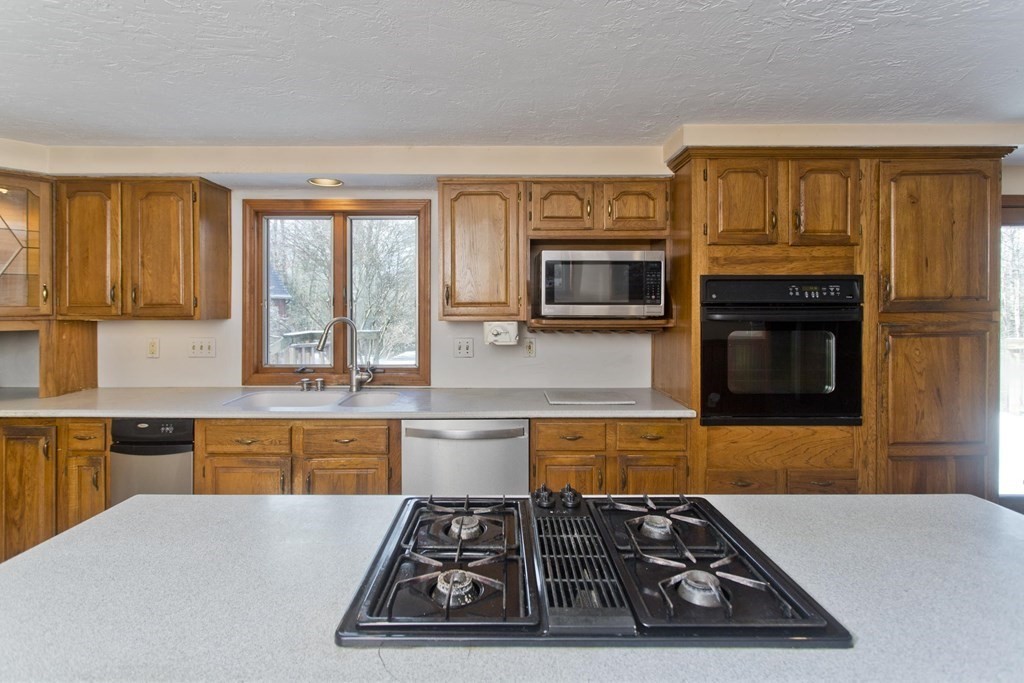 200 Town Farm Road Monson, MA 01057 - Photo 5 of 42 a kitchen with stainless steel appliances granite countertop a stove and a sink