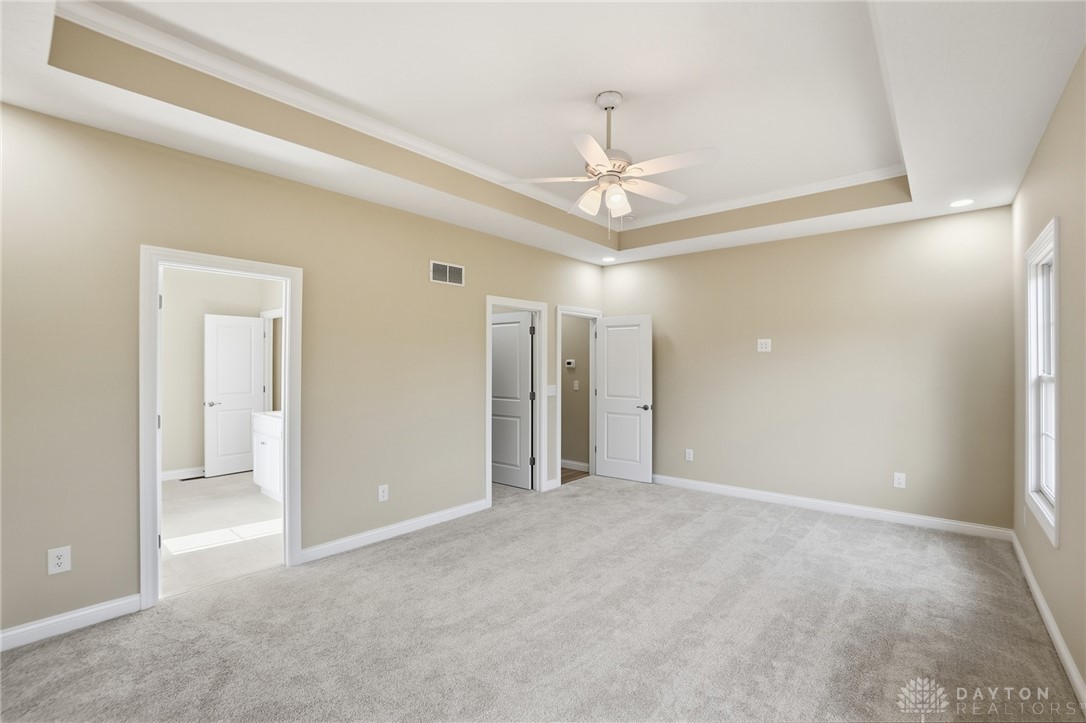 4600 Beal Road Franklin, OH 45005 - Photo 16 of 42 This spacious primary bedroom offers ample room with soft carpeting and elegant tray ceilings.