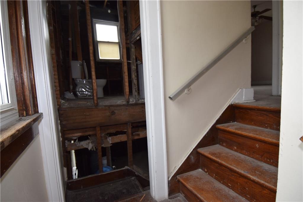 621 Watson Street Coraopolis, PA 15108 - Photo 16 of 32 a view of staircase with lots of frames on wall and a window