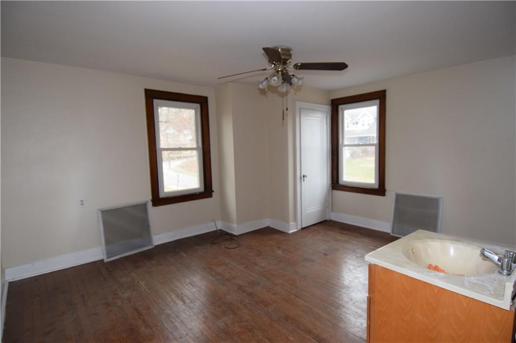 621 Watson Street Coraopolis, PA 15108 - Photo 17 of 32 a view of an empty room with wooden floor and a window