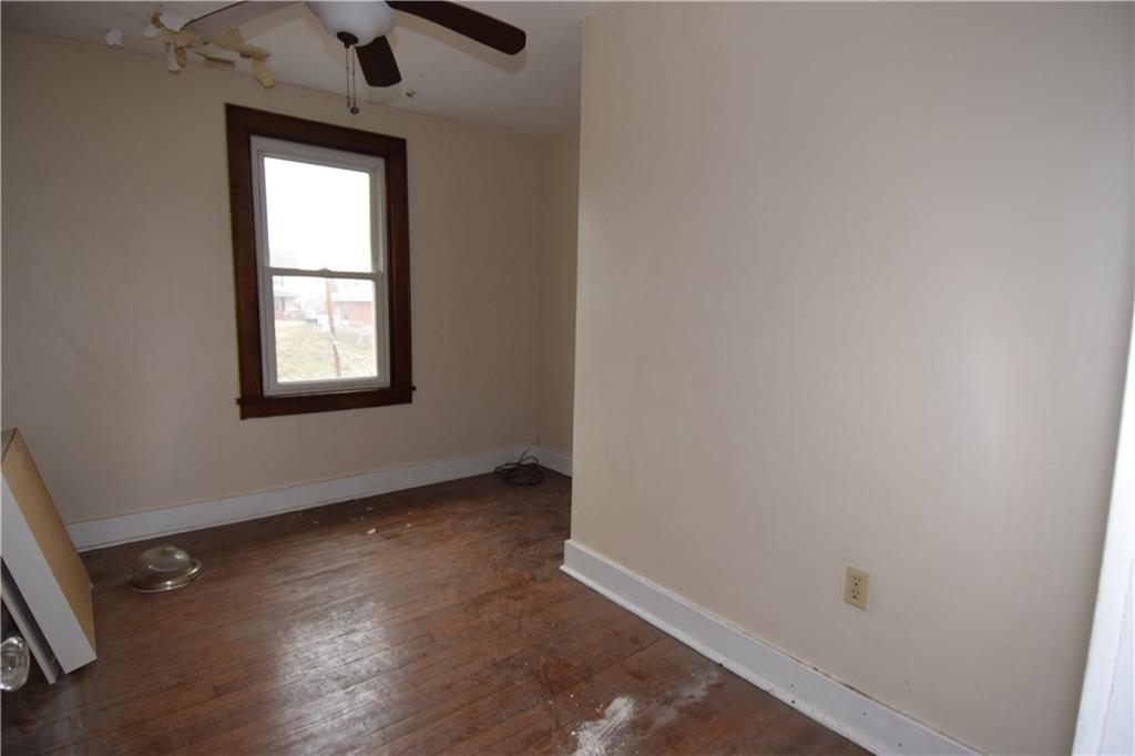 621 Watson Street Coraopolis, PA 15108 - Photo 21 of 32 an empty room with wooden floor cabinet and windows