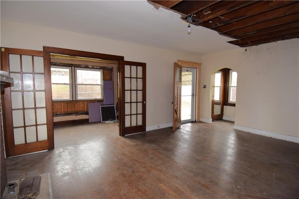 621 Watson Street Coraopolis, PA 15108 - Photo 5 of 32 an empty room with wooden floor and windows