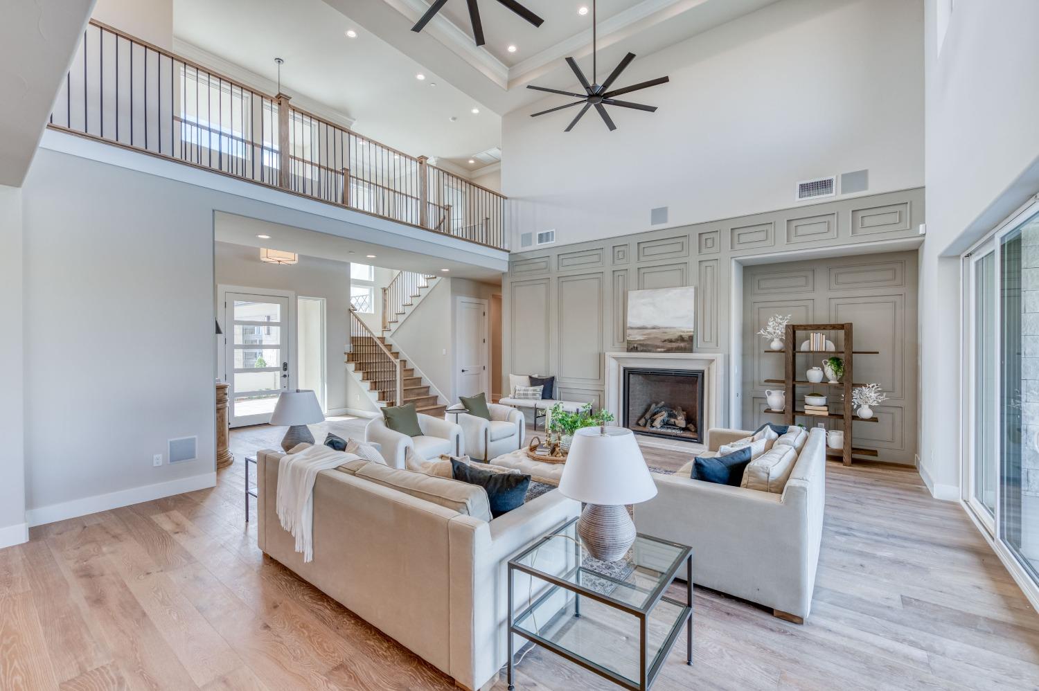 881 Terrace Place Madera, CA 93636 - Photo 17 of 85 a living room with furniture a fireplace and a chandelier