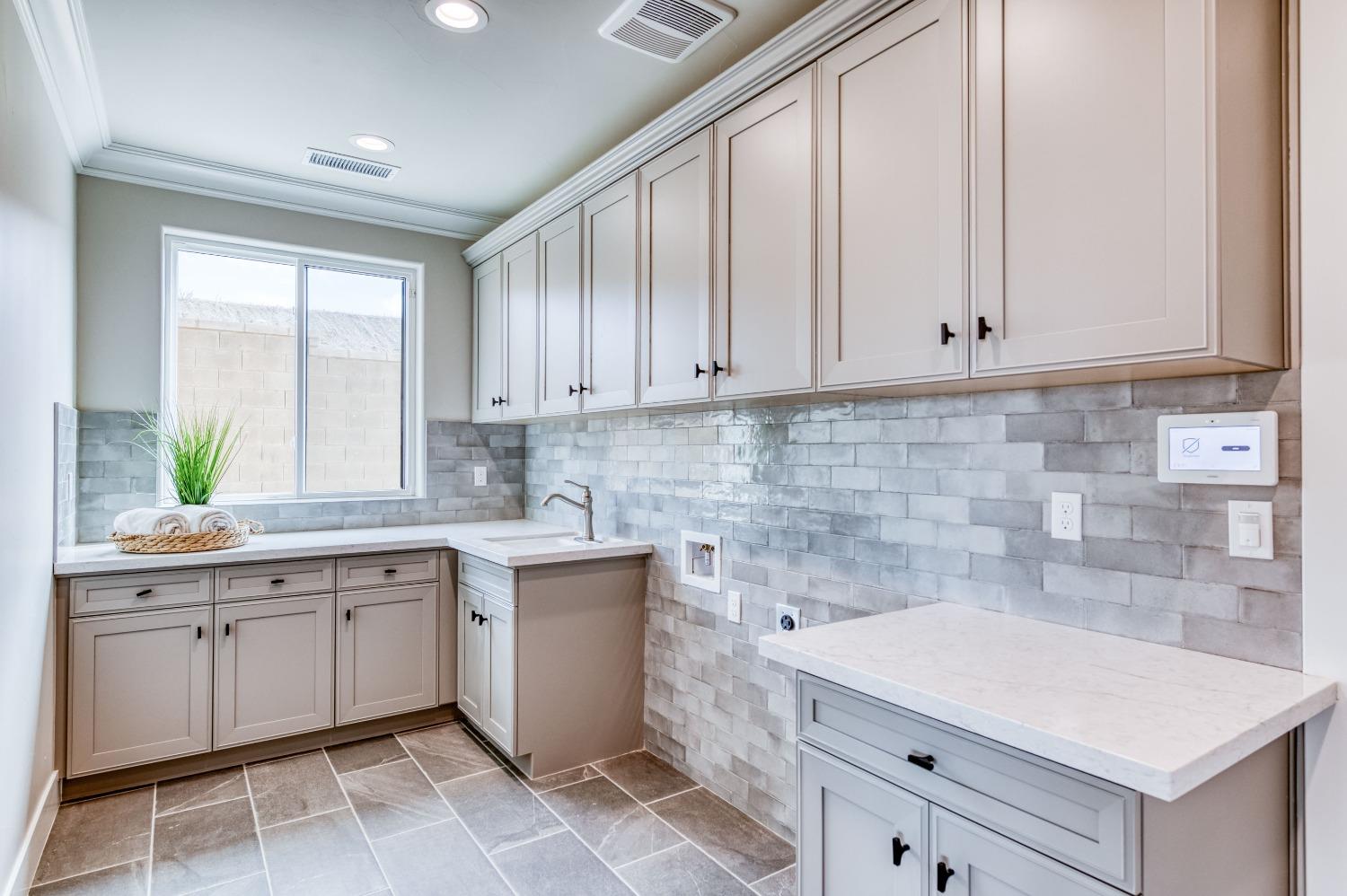 881 Terrace Place Madera, CA 93636 - Photo 26 of 85 a kitchen with a sink and cabinets