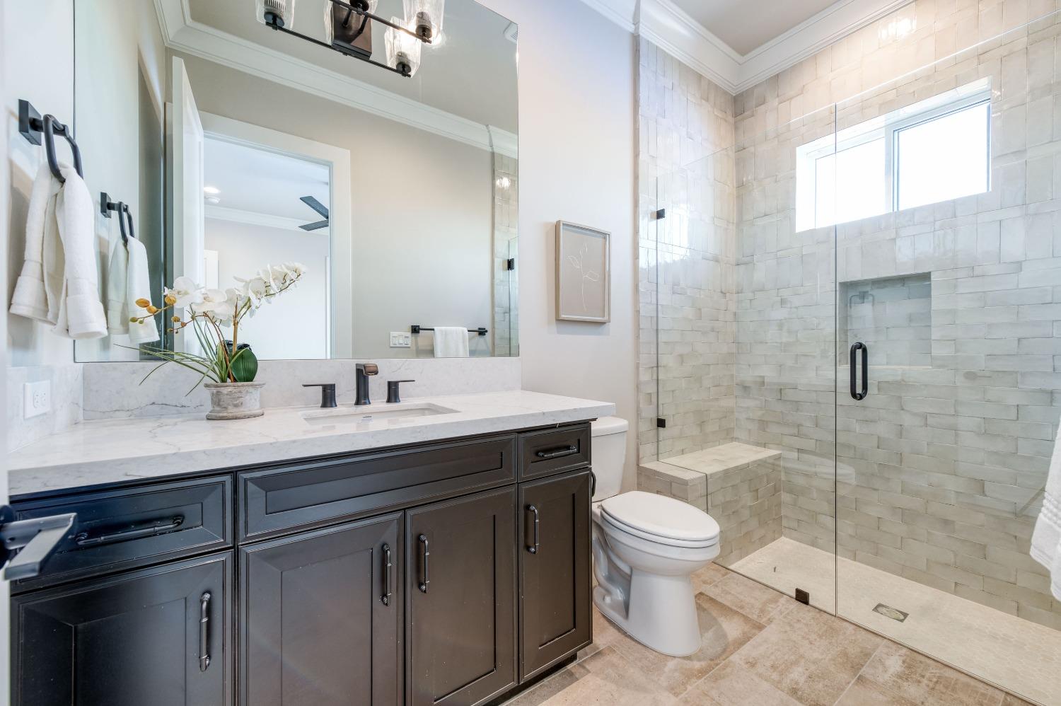 881 Terrace Place Madera, CA 93636 - Photo 28 of 85 a bathroom with a sink a toilet and a large mirror