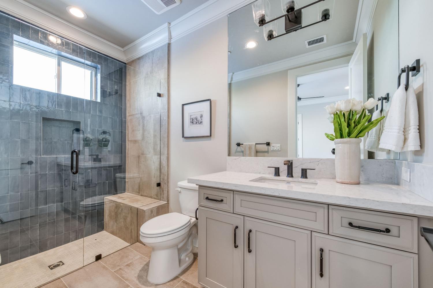 881 Terrace Place Madera, CA 93636 - Photo 31 of 85 a bathroom with a granite countertop sink a toilet and shower