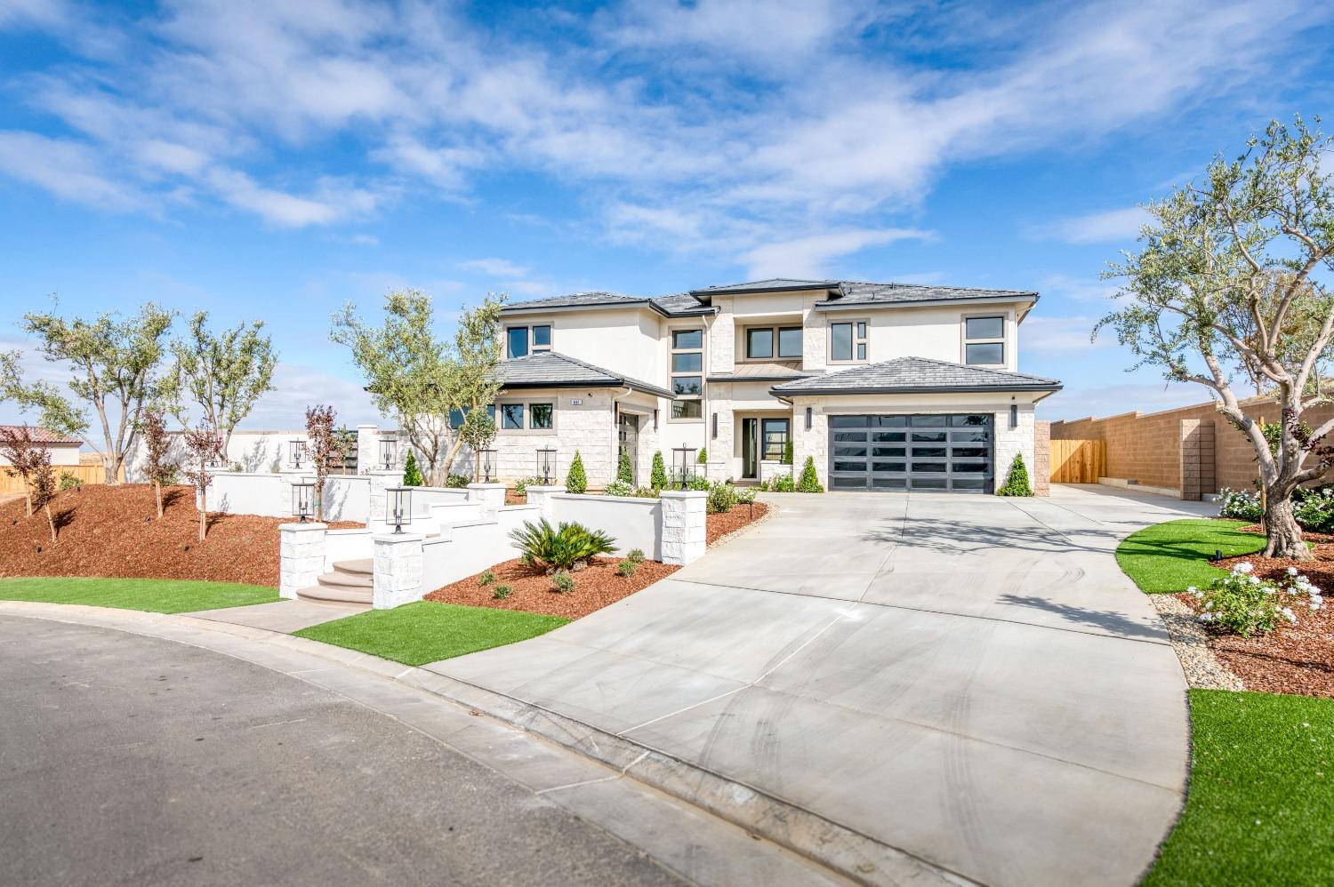 881 Terrace Place Madera, CA 93636 - Photo 4 of 85 a front view of a house with a yard and garage