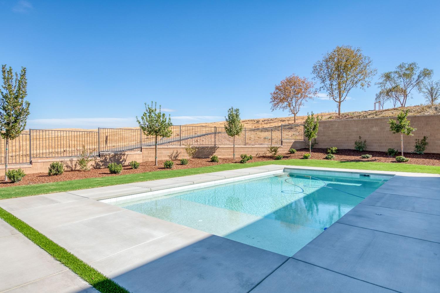 881 Terrace Place Madera, CA 93636 - Photo 51 of 85 a view of a swimming pool and a yard