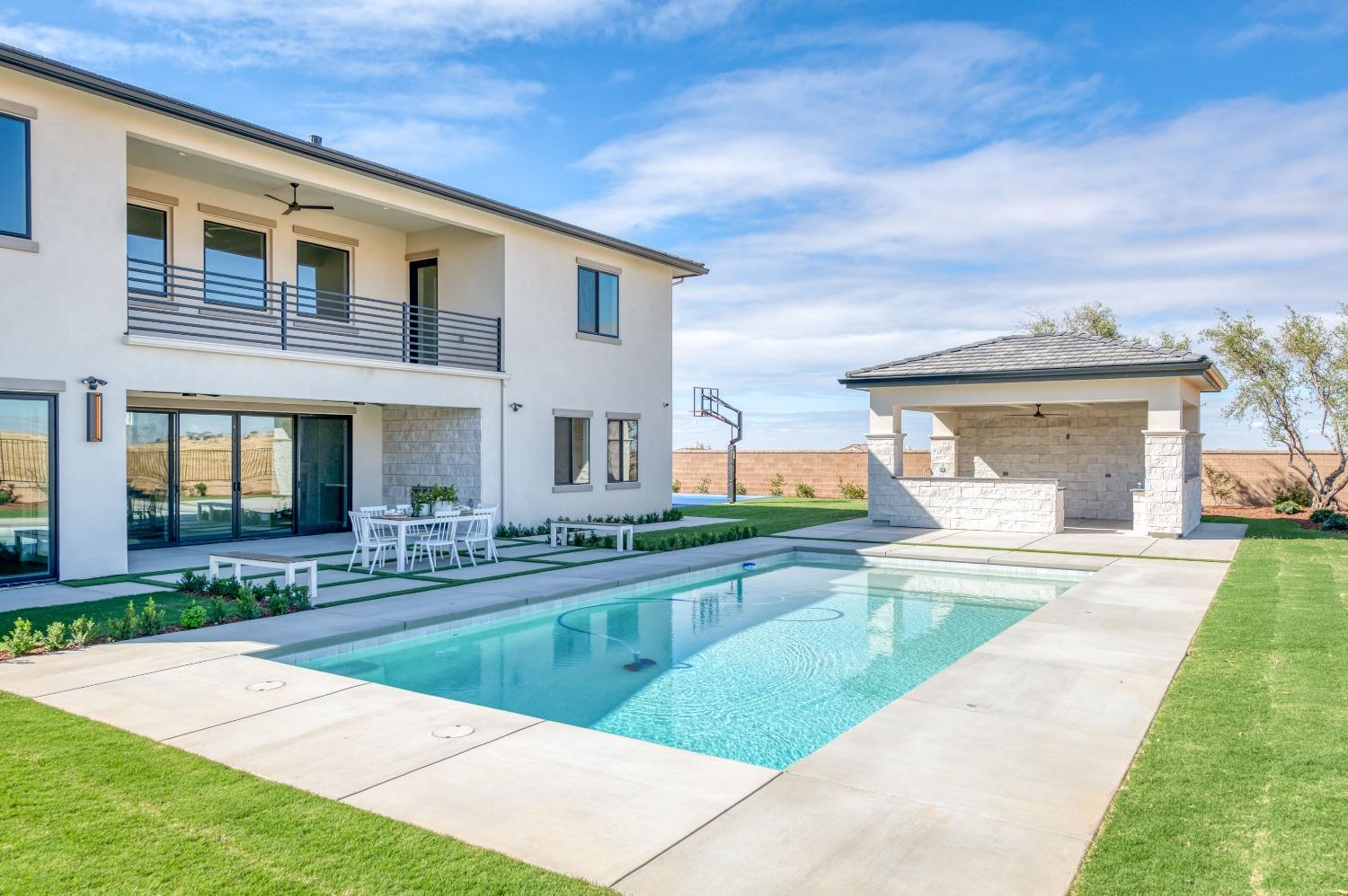 881 Terrace Place Madera, CA 93636 - Photo 55 of 85 a view of a house with swimming pool and a yard