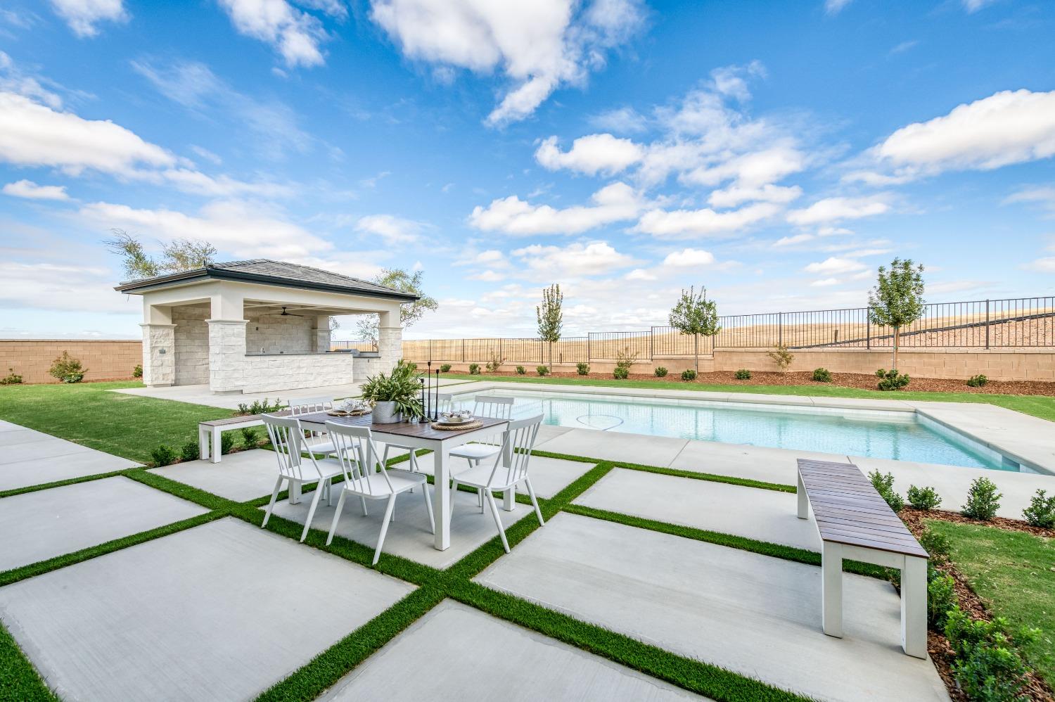 881 Terrace Place Madera, CA 93636 - Photo 60 of 85 a view of a patio with table and chairs and potted plants
