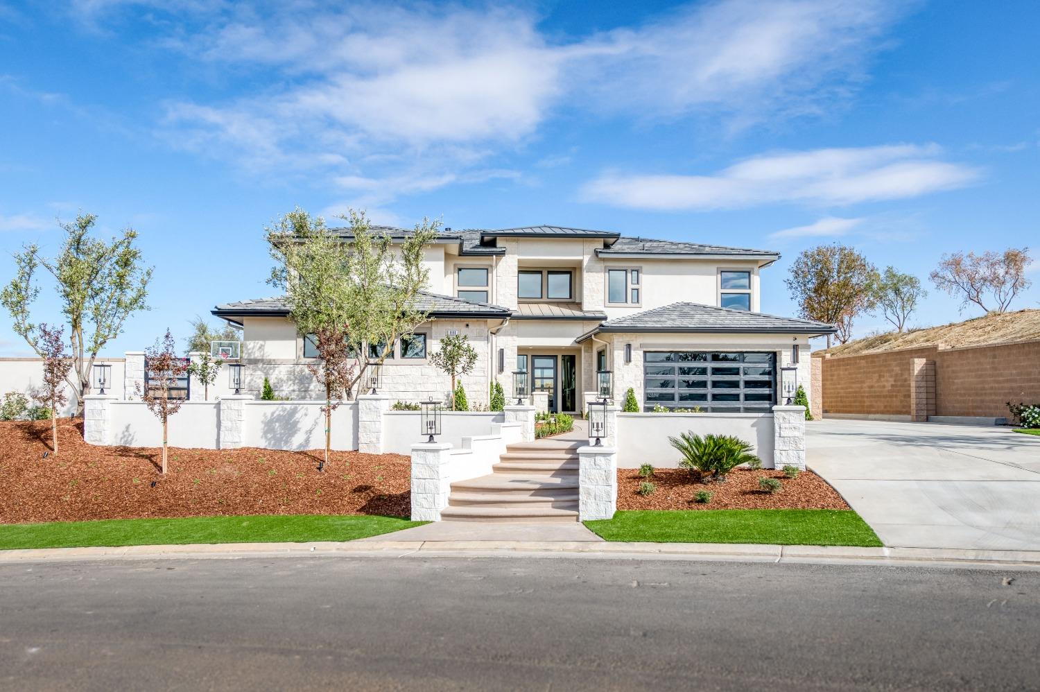 881 Terrace Place Madera, CA 93636 - Photo 6 of 85 a front view of a house with a yard and garage
